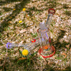 Borosilicate glass on grass with flowers